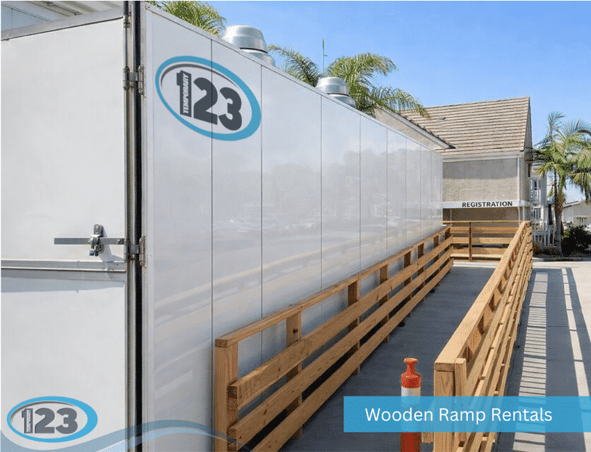 Wooden access ramp alongside a white kitchen trailer